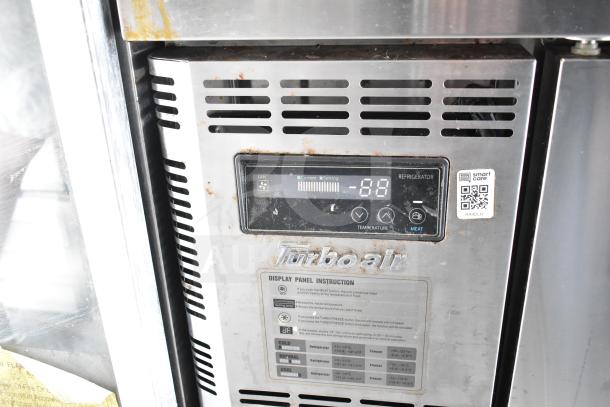 Turbo Air display and settings panel on food trailer refrigeration unit, showing temperature settings and QR code.