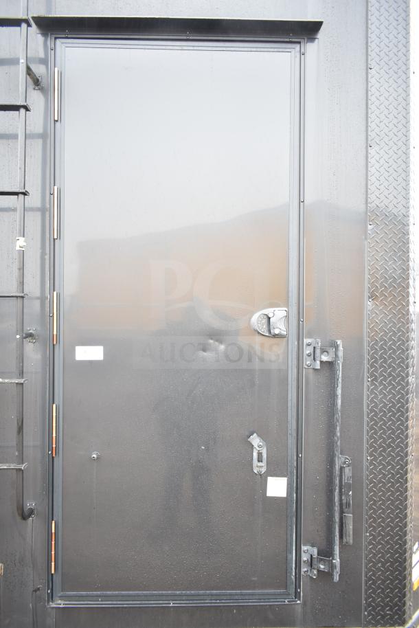 2020 Southern Dimensions Group all-black mobile commissary trailer door with secure locks and ladder.