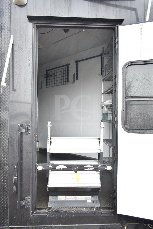 2020 Southern Dimensions Group mobile commissary trailer, open entrance, showing interior shelving, used condition.