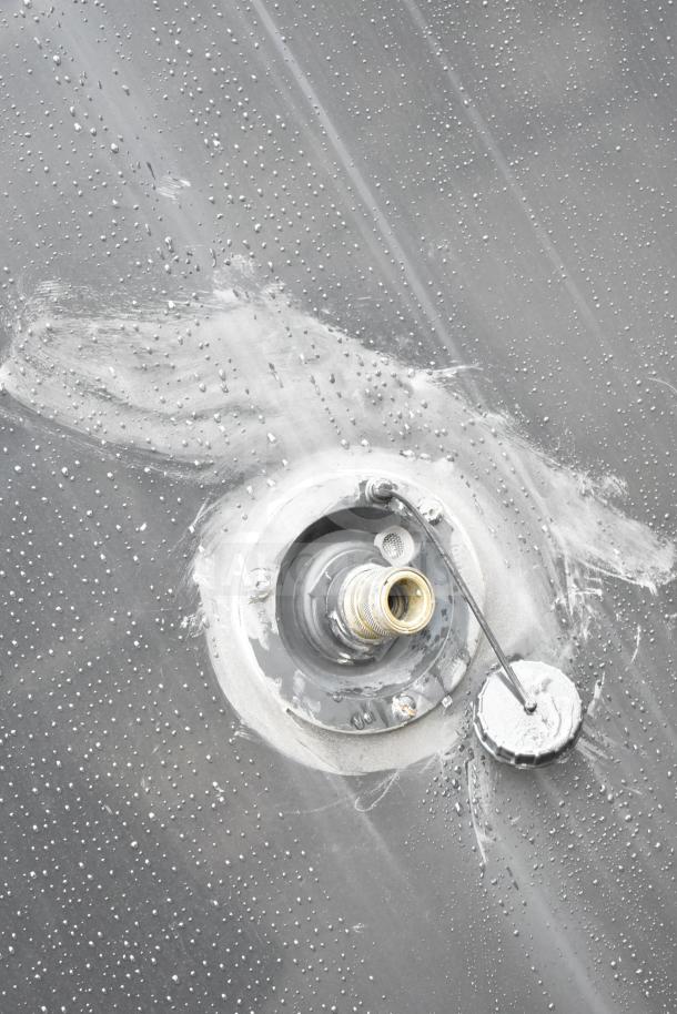 Close-up of the Southern Dimensions Group mobile trailer's exterior fuel filler cap with visible texture and wear.