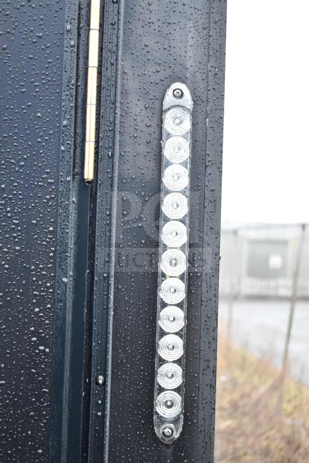 All-black 2020 Southern Dimensions Group trailer with water droplets on LED light strip and hinge detail.