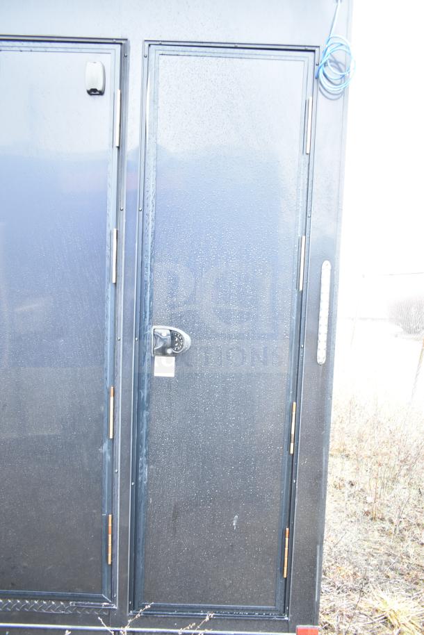2020 Southern Dimensions Group 8.5' x 20' all-black mobile commissary trailer. Features include tandem axle, 14,000 lb GVWR, Coleman Mach AC, dual John Boos sinks, Bosch water heater, IT/network cabinet, and wire shelving.