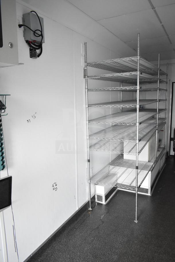 2020 Southern Dimensions Group 8.5' x 20' black mobile trailer interior with wire shelving and network cabinet.