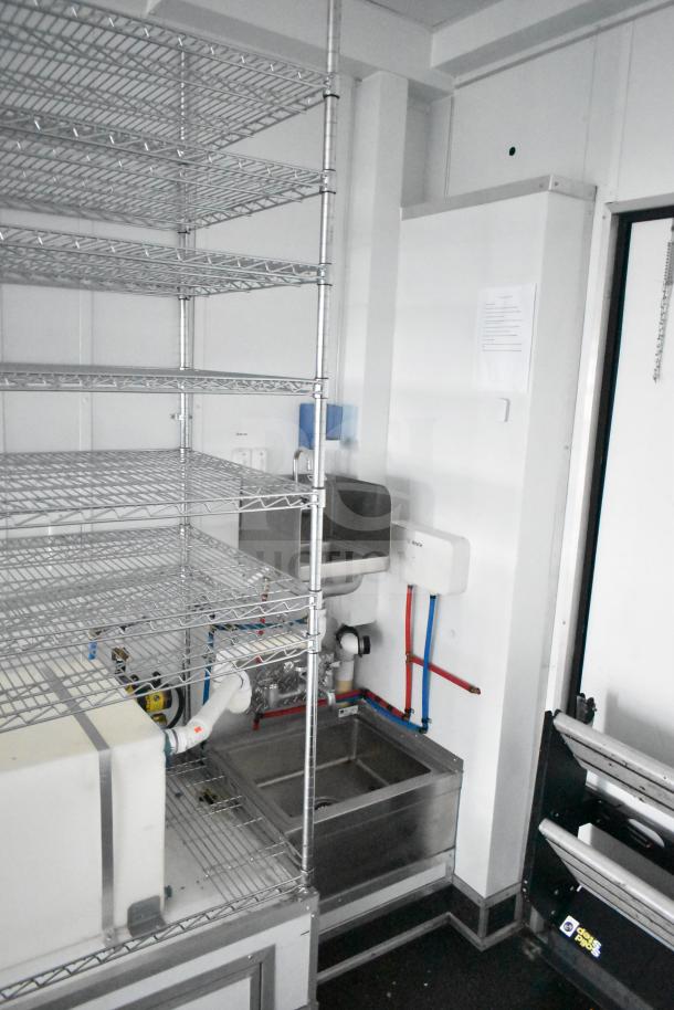 2020 Southern Dimensions Group mobile trailer interior, featuring wire shelving, dual John Boos sinks, Bosch water heater.