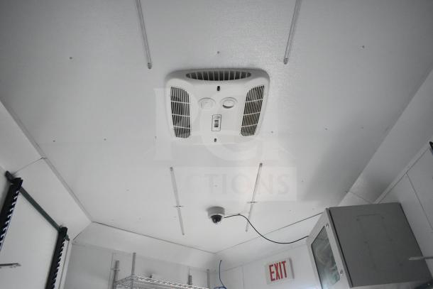 2020 Southern Dimensions mobile trailer interior with Coleman Mach AC, wire shelving, network cabinet, and exit sign visible.