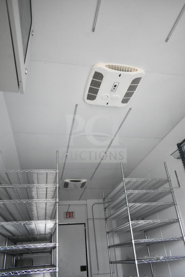 2020 Southern Dimensions Group mobile commissary trailer interior with Coleman Mach AC, wire shelving, and IT cabinet.