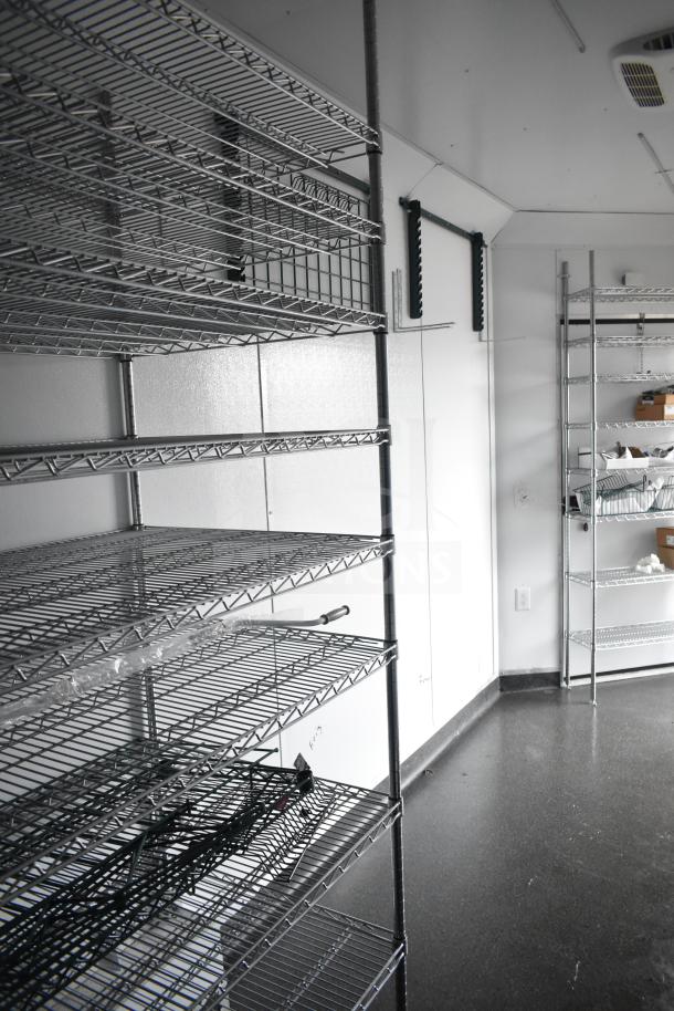 2020 Southern Dimensions 8.5' x 20' all-black trailer interior with wire shelving and IT/network cabinet.