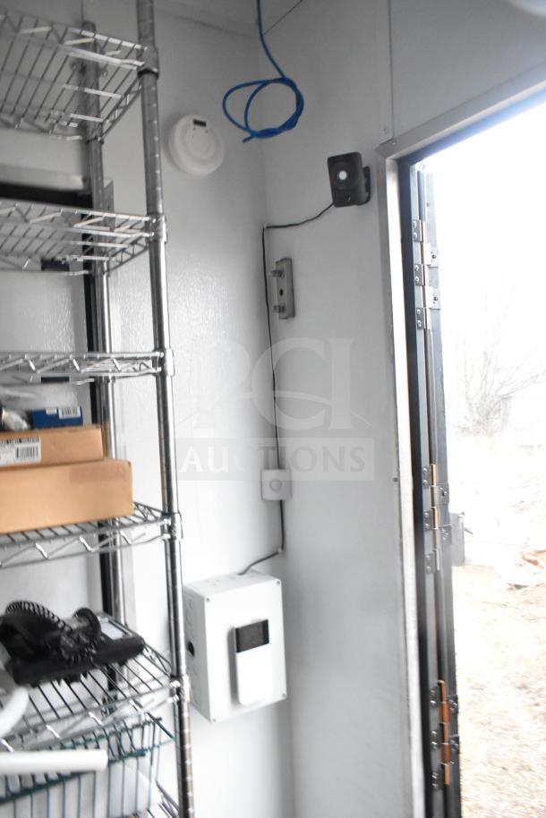Interior of 2020 Southern Dimensions 8.5'x20' mobile commissary trailer, featuring wire shelving and IT/network cabinet.