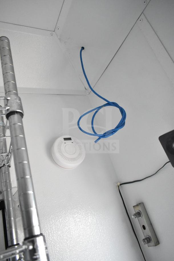 Interior of 2020 Southern Dimensions Group Mobile Trailer showing wire shelving, smoke detector, and network cable installation.