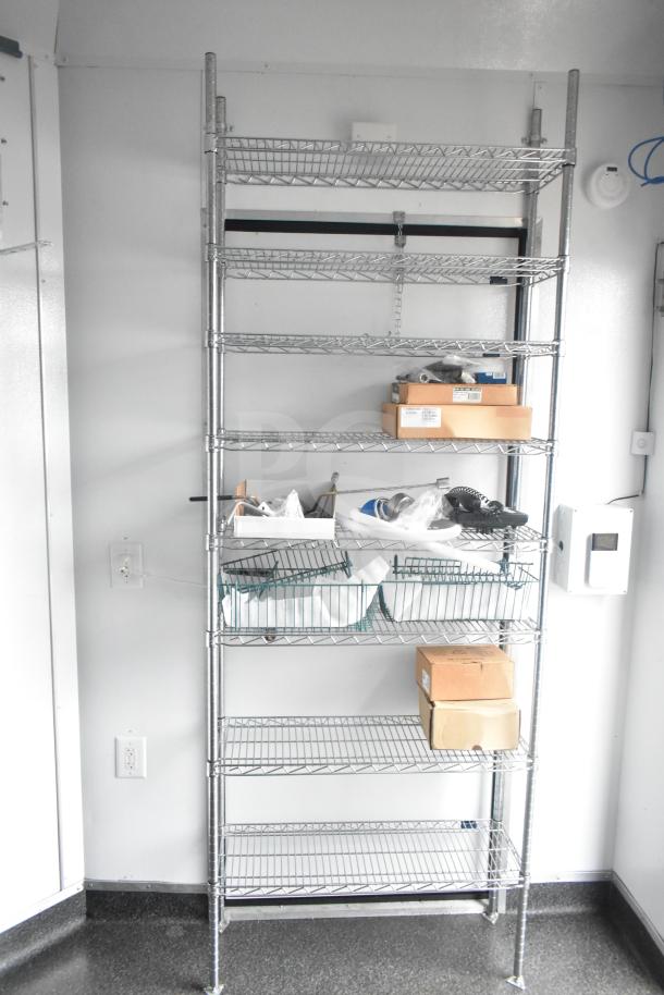 Interior of 2020 Southern Dimensions Group mobile trailer with wire shelving, boxes, and storage items.