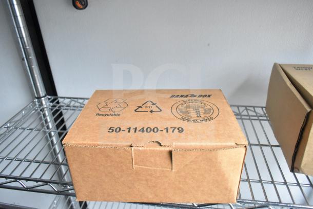 Cardboard box with "Recyclable" and "Bana Box" logos, marked 50-11400-179. Stored on wire shelving.