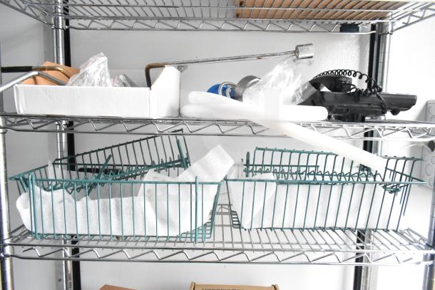 Wire shelving in the 2020 Southern Dimensions Group mobile trailer with assorted items including metal rods and baskets.