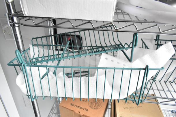 Metal wire shelving with a teal basket, containing packing material and a white plastic holder. Cardboard box below on shelf.
