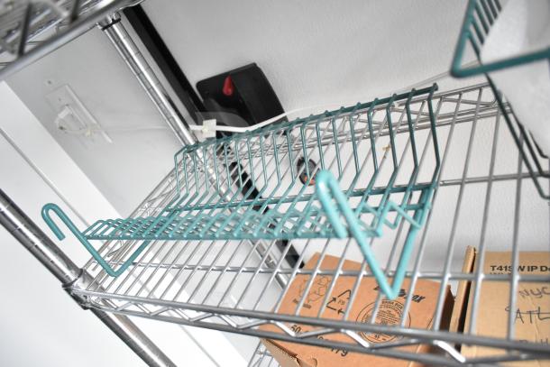 Wire shelving inside 2020 Southern Dimensions Group mobile commissary trailer, featuring rack and visible cardboard boxes.