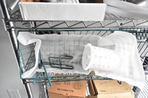Metal wire shelving with white foam padding, green holder, and white plastic basket. Cardboard boxes below, one labeled "Verizon".