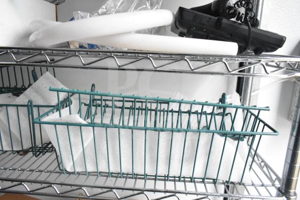 Stainless steel wire shelving in 2020 Southern Dimensions Group trailer with storage basket and insulation sheets.