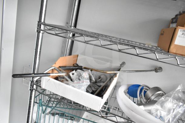Interior wire shelving in the 2020 Southern Dimensions Group mobile trailer, featuring assorted metal components.