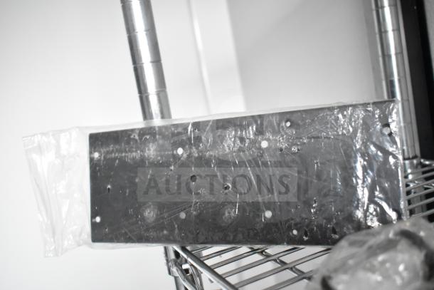 Close-up of a metallic component, wrapped in transparent plastic, resting on wire shelving. Part of a mobile commissary trailer.