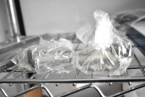 Stainless steel connectors in plastic wrap on wire shelving inside the 2020 Southern Dimensions Group trailer.