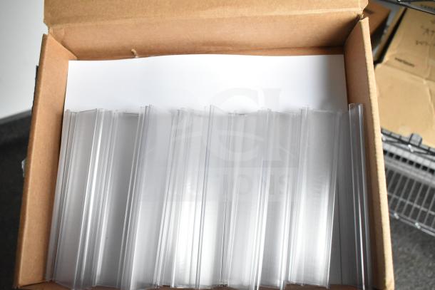 Box of clear plastic sign holders inside a cardboard box.