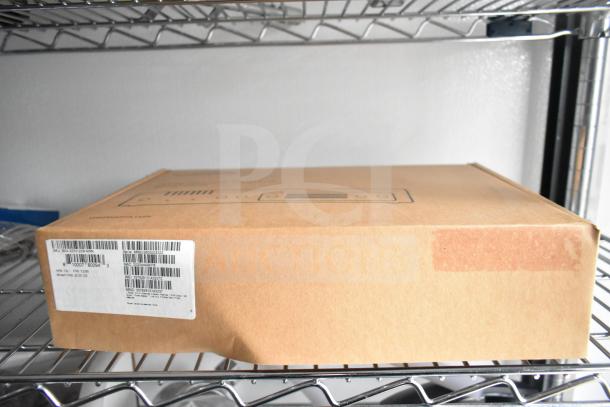 Cardboard box on wire shelving with visible barcode and shipping label.