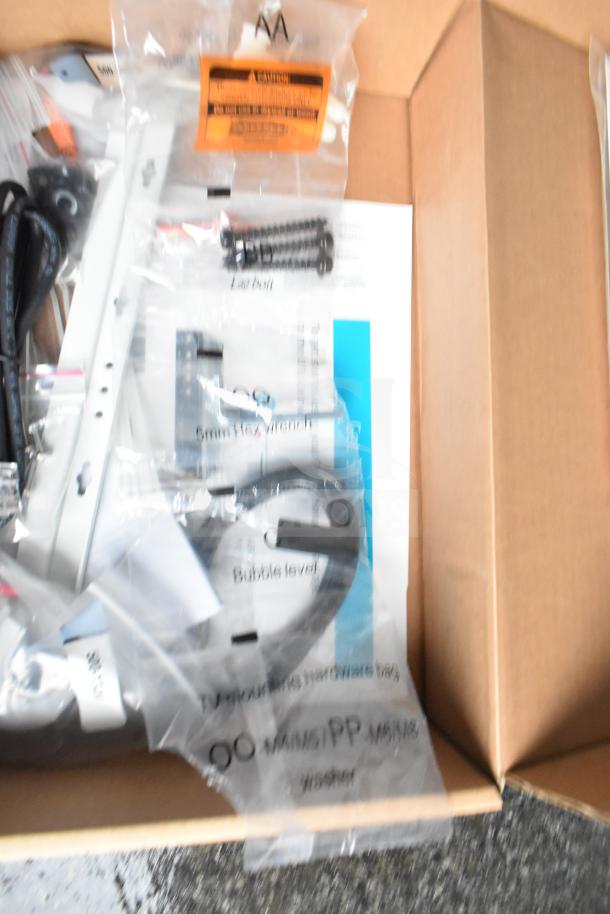 A box containing hardware and installation materials. Visible labels show component descriptions, such as "Bubble level" and "Washer."