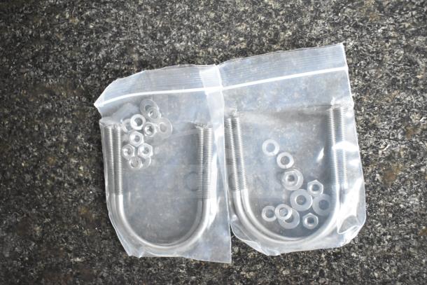 Ziploc bags containing U-bolts, nuts, and washers; likely hardware for the 2020 Southern Dimensions trailer.