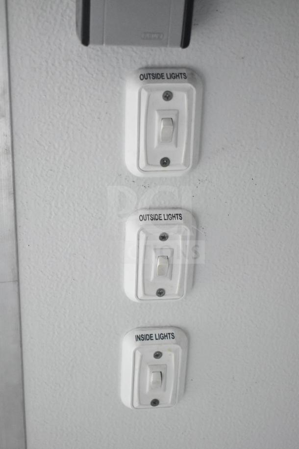 Light switches labeled "Outside Lights" and "Inside Lights" inside a 2020 Southern Dimensions Group mobile trailer.