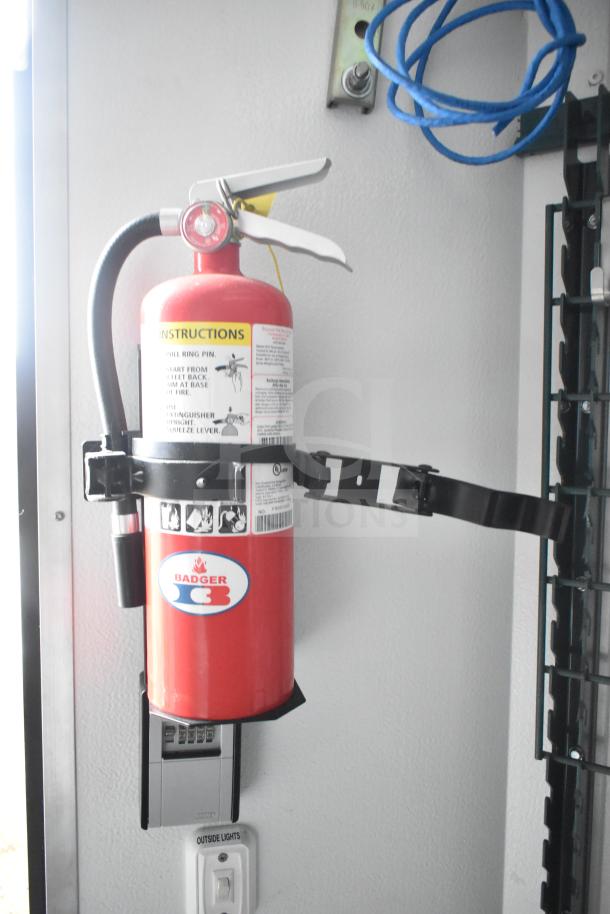 Red Badger fire extinguisher mounted inside a Southern Dimensions Group mobile commissary trailer.