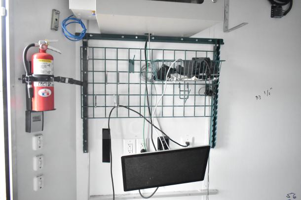 2020 Southern Dimensions mobile trailer interior, featuring wire shelving, fire extinguisher, IT/network cabinet, and outlet panel.