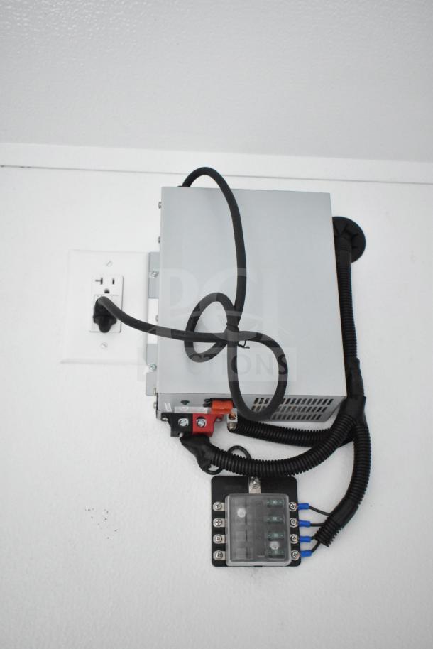 Wall-mounted electrical unit with cables and outlets inside a 2020 Southern Dimensions Group mobile trailer.