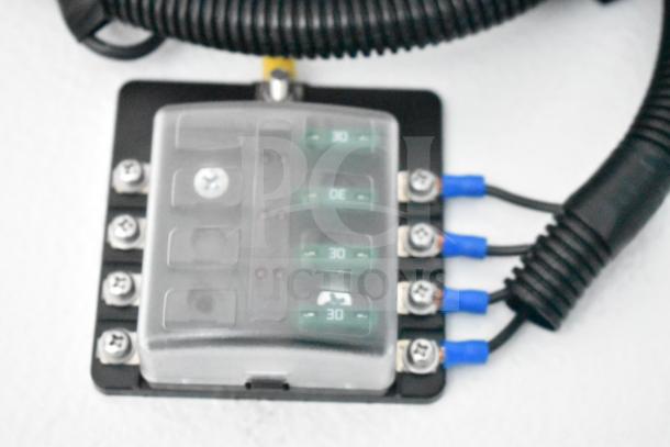 Close-up view of electronic component inside a 2020 Southern Dimensions Group mobile commissary trailer, showing wiring and fuse box.