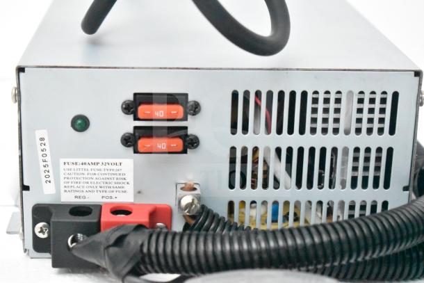 Rear view of an electrical unit with dual 40 amp fuses, cooling vents, power connections, and caution labeling.