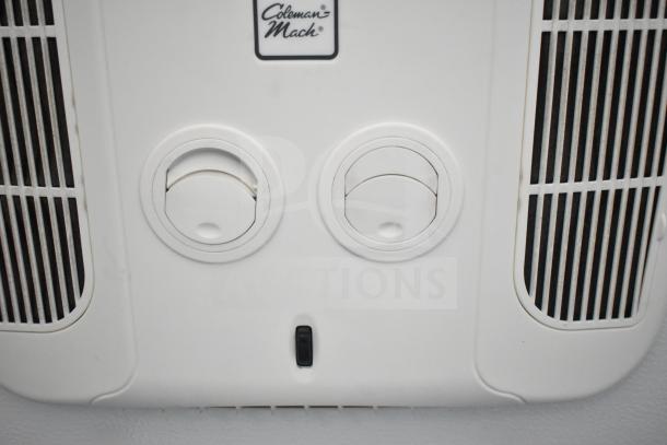 Coleman Mach AC vent panel on Southern Dimensions Group mobile trailer ceiling. Features dual dials and switch.