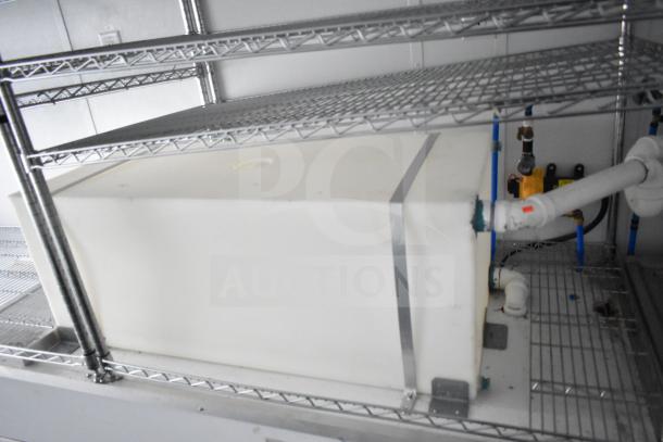 Interior of 2020 Southern Dimensions Group mobile commissary trailer, featuring wire shelving and piping system.
