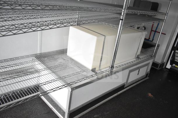 2020 Southern Dimensions Group 8.5' x 20' trailer interior with wire shelving and storage tank.