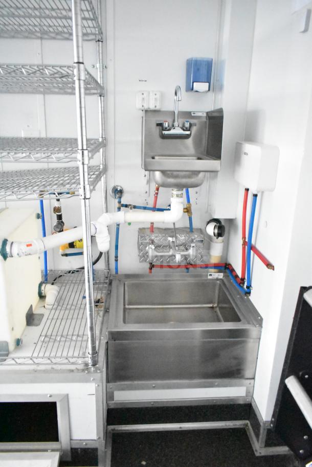 2020 Southern Dimensions Group mobile trailer interior with dual John Boos sinks, Bosch water heater, and wire shelving.