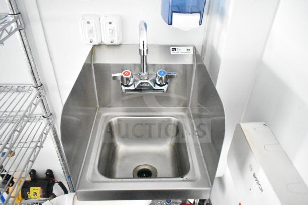 Stainless steel sink with dual faucet handles in a 2020 Southern Dimensions mobile commissary trailer. Bosch label visible.