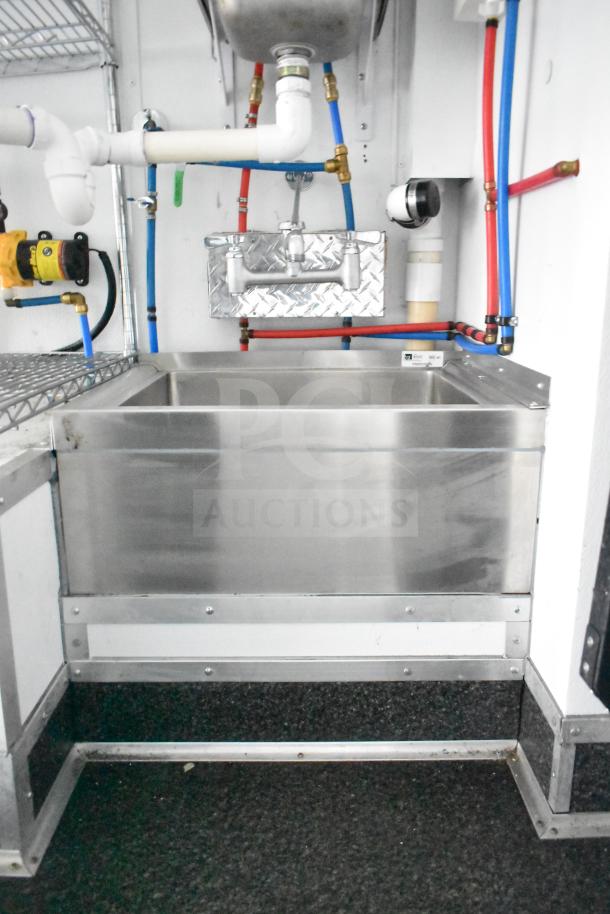 Southern Dimensions 2020 mobile commissary trailer interior showing dual John Boos sinks, plumbing, and wire shelving.