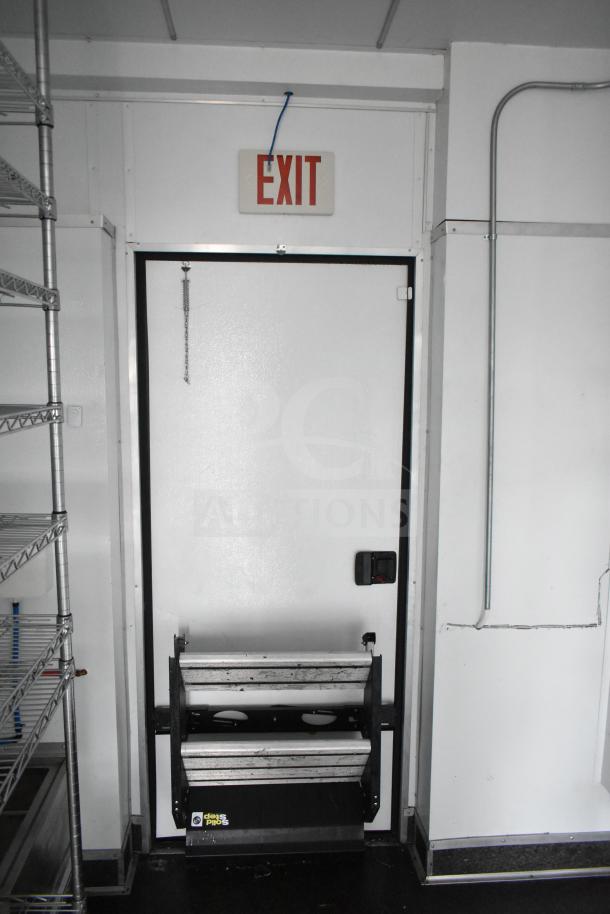 2020 Southern Dimensions 8.5' x 20' mobile trailer interior, showcasing wire shelving and an exit door with folding step.