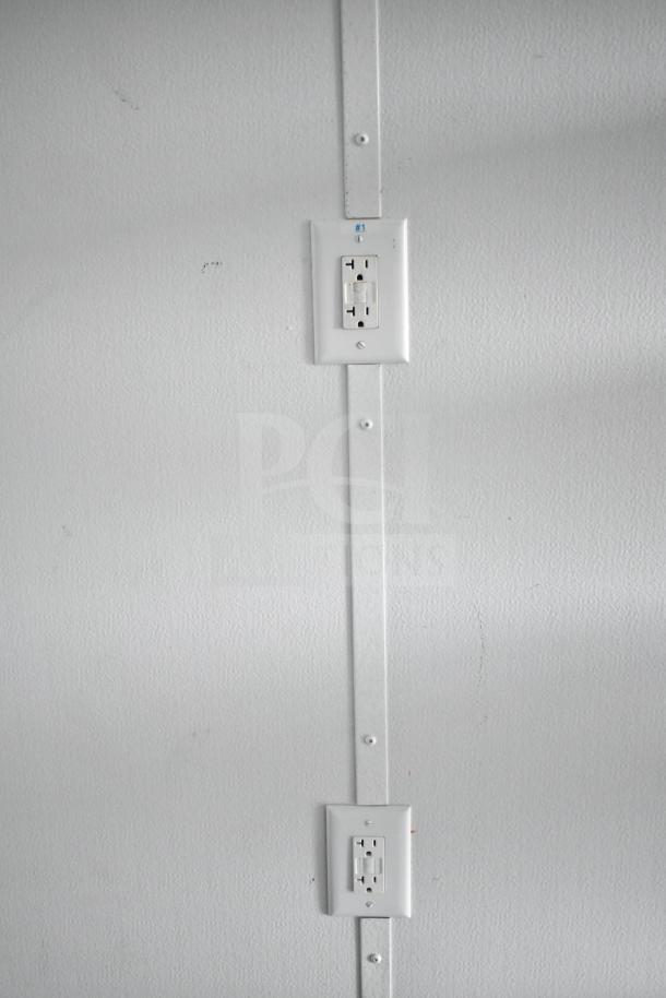 2020 Southern Dimensions Group mobile trailer wall with dual outlets and labeled metal strip.