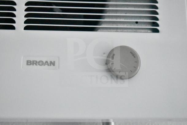 Broan heater control knob with low to high settings, shown on a white panel.
