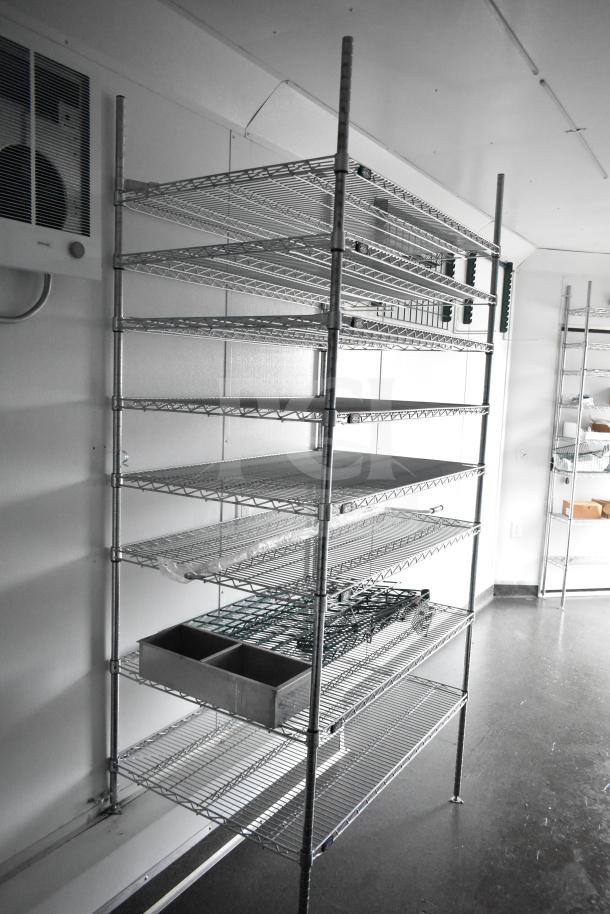 Metallic wire shelving inside a 2020 Southern Dimensions Group mobile commissary trailer. Features adjustable shelves for storage.