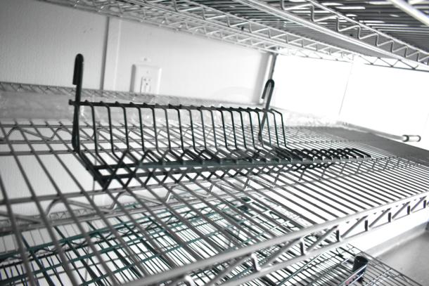 Interior of a 2020 Southern Dimensions Group mobile commissary trailer showing wire shelving and IT/network cabinet.