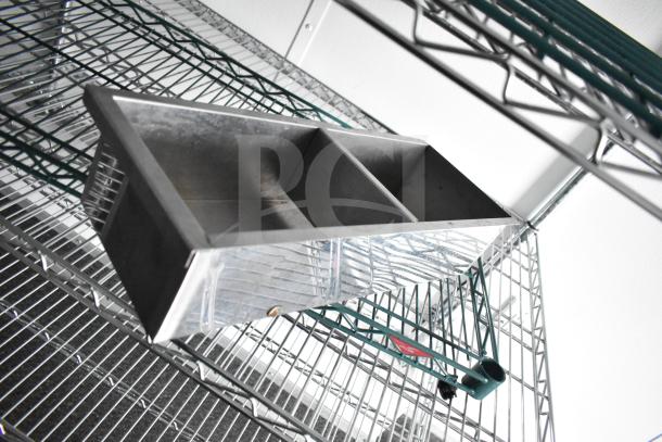Alt Text: Close-up of wire shelving with an industrial metal bin in a Southern Dimensions Group mobile trailer.