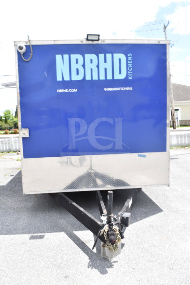 Rock Solid Cargo 28ft food trailer, features CaptiveAire Hood, refrigeration, Nieco Charbroiler. "NBRHD Kitchens" logo on side.