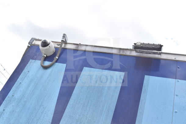 Exterior of 2021 Rock Solid Cargo 28ft food trailer, featuring surveillance camera setup, blue paneling. VIN: 7H2BE2837ND041749.
