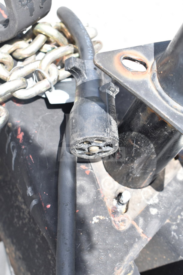 Close-up of a 2021 Rock Solid Cargo 28ft food trailer hitch showing connector and chains. VIN: 7H2BE2837ND041749.
