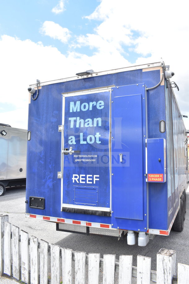 2021 Rock Solid Cargo 28ft food trailer, rear view, blue exterior. Features CaptiveAire hood, refrigeration, Nieco charbroiler. VIN: 7H2BE2837ND041749.