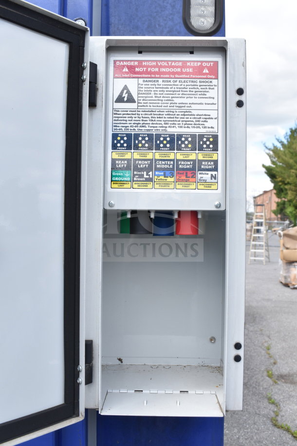 Electrical panel open on the 2021 Rock Solid Cargo food trailer. High voltage warning label and connection instructions visible.